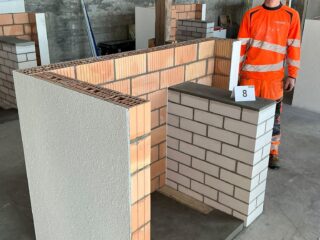 LernenderMaurer EFZ beim QV-Probelauf in Landquart mit seinem gemauertem Übungsobjekt